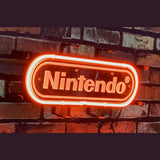 Red-orange neon sign displaying the word 'Nintendo' in a rounded rectangular shape against a dark brick wall background.