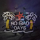 Neon sign with outlines of two white palm trees, a red sun, and yellow lines framing the white text 'NO BAD DAYS' on a black background.