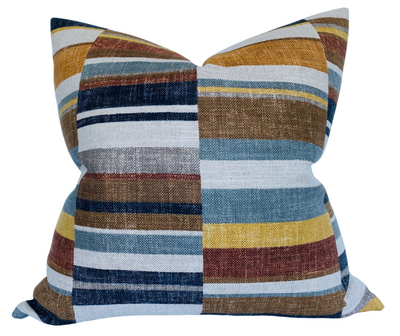 Nomad Block Print Pillow Cover in Rust displayed on a sofa