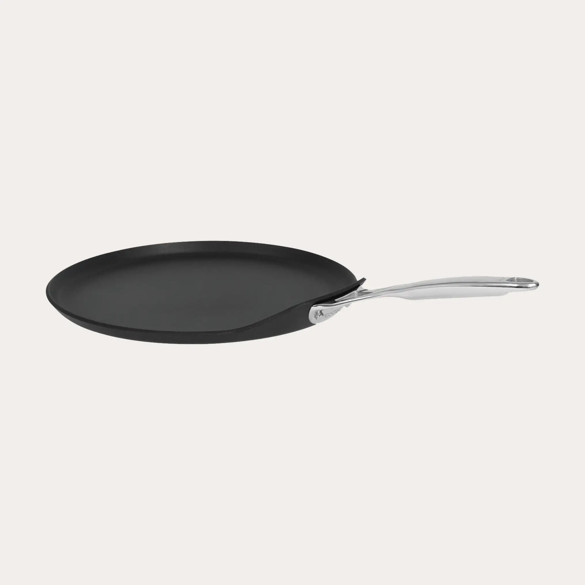CRISTEL USA Crepe Pan with fixed stainless-steel handle on stovetop