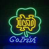 Neon sign featuring a green shamrock outline with yellow interlocking ND letters inside and blue cursive "Go Irish" text below on a black background.