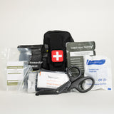 Black compact first aid pouch marked with a red cross, surrounded by medical supplies including hemostatic gauze, chest seal, tourniquet, trauma shears, and gloves on a white background.