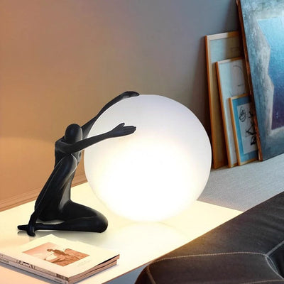 Orb Modern Sculpture Lamp in black and red resin finish, spherical design emitting soft ambient light