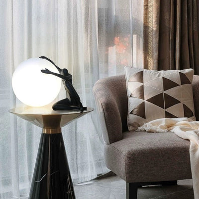 Orb Modern Sculpture Lamp in black and red resin finish, spherical design emitting soft ambient light