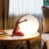 Orb Modern Sculpture Lamp in black and red resin finish, spherical design emitting soft ambient light