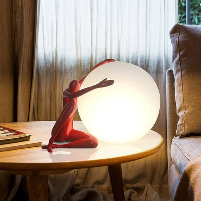 Orb Modern Sculpture Lamp in black and red resin finish, spherical design emitting soft ambient light