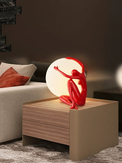 Orb Modern Sculpture Lamp in black and red resin finish, spherical design emitting soft ambient light