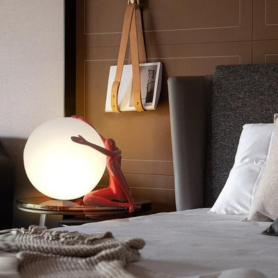 Orb Modern Sculpture Lamp in black and red resin finish, spherical design emitting soft ambient light