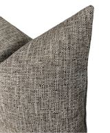 Close-up of two textured fabric pillow covers in a chestnut color with a woven pattern of dark brown, gray, and off-white threads, showing soft corners.