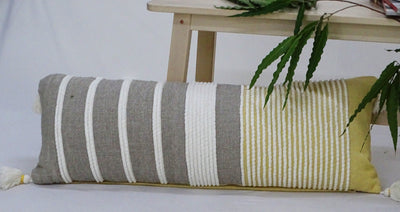 Decorative Long Grey Stripes Throw Pillow in grey, white, and ocher stripes on a sofa