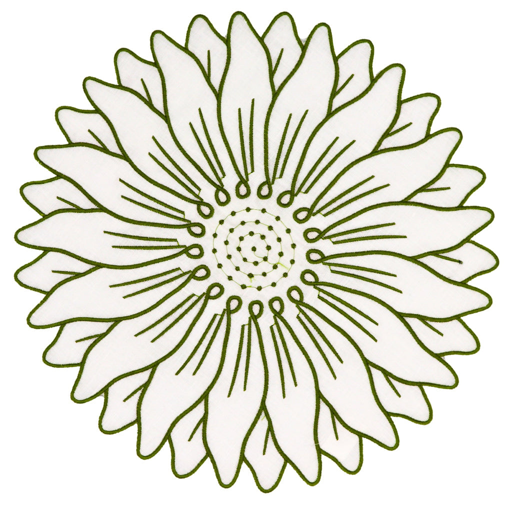 Set of four white linen Olive Bloom placemats with green floral embroidery arranged on a wooden table