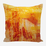 Square pillow with abstract orange and yellow brushstroke pattern resembling layered paint textures.