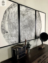Three-panel black and white woodcut print showing detailed rings of a 372-year-old Sitka spruce tree mounted on a wall above a wooden dresser with books and a vintage record player.
