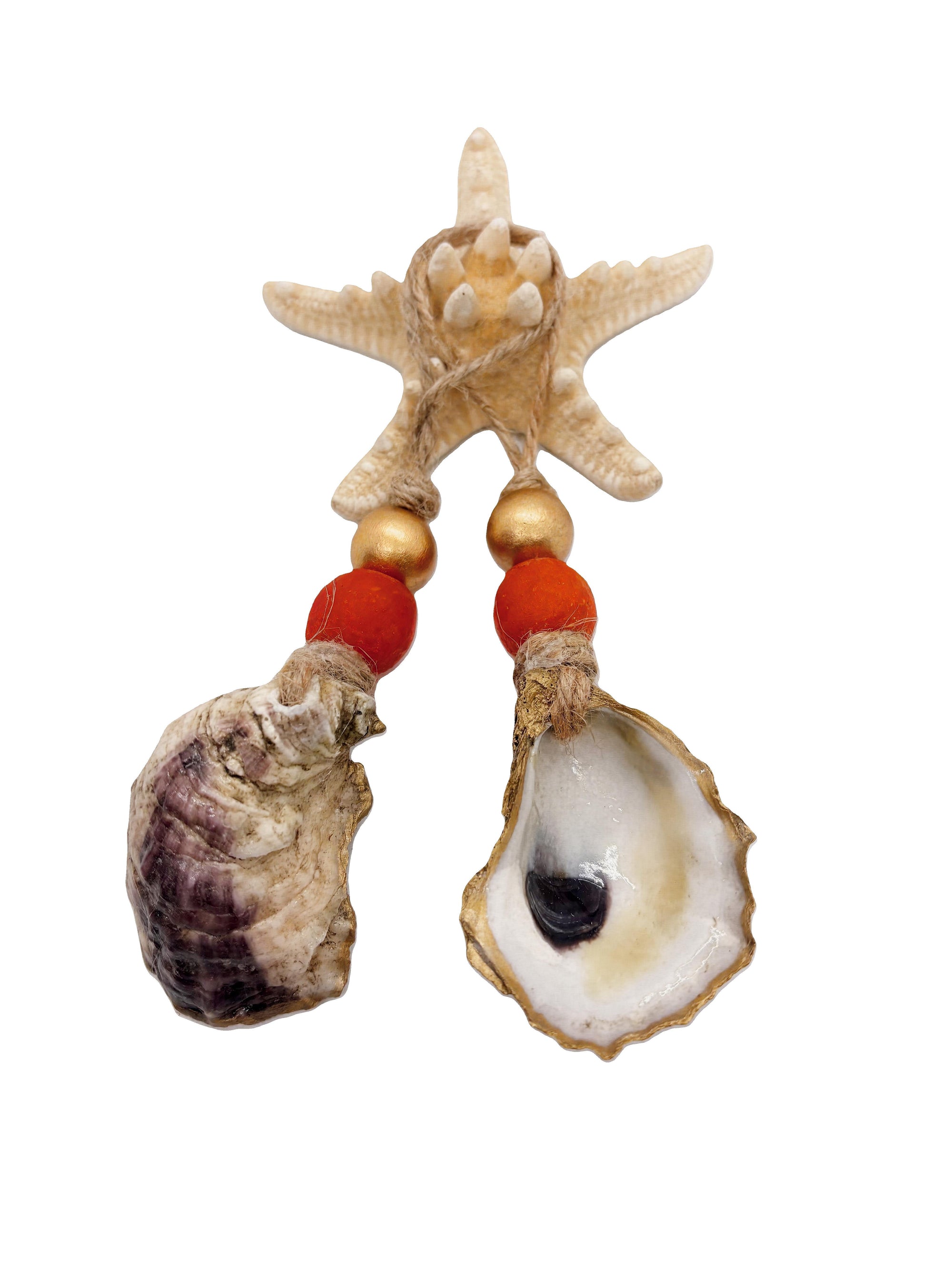 Two Autumn Tides ornaments with orange sea glass and gold beads displayed hanging and styled on bottles and cabinet knobs.