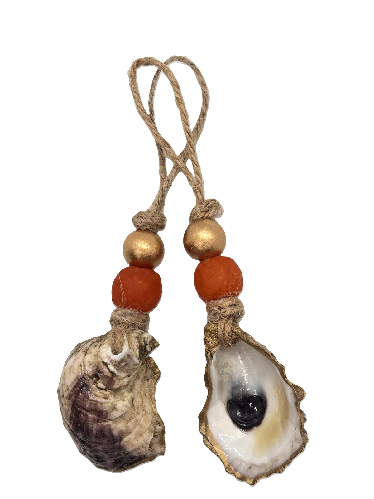 Two hanging ornaments featuring natural oyster shells with textured brown, white, and black patterns, each accented with a gold and an orange bead, tied with rustic twine loops.