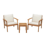 Two wooden armchairs with cream cushions flanking a small square wooden side table, all with clean lines and a minimalist design.