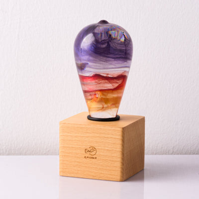 Passion Light Bulb decorative resin LED lamp with artistic glow, shown with wooden base options