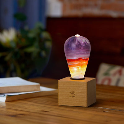 Passion Light Bulb decorative resin LED lamp with artistic glow, shown with wooden base options