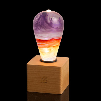 Passion Light Bulb decorative resin LED lamp with artistic glow, shown with wooden base options