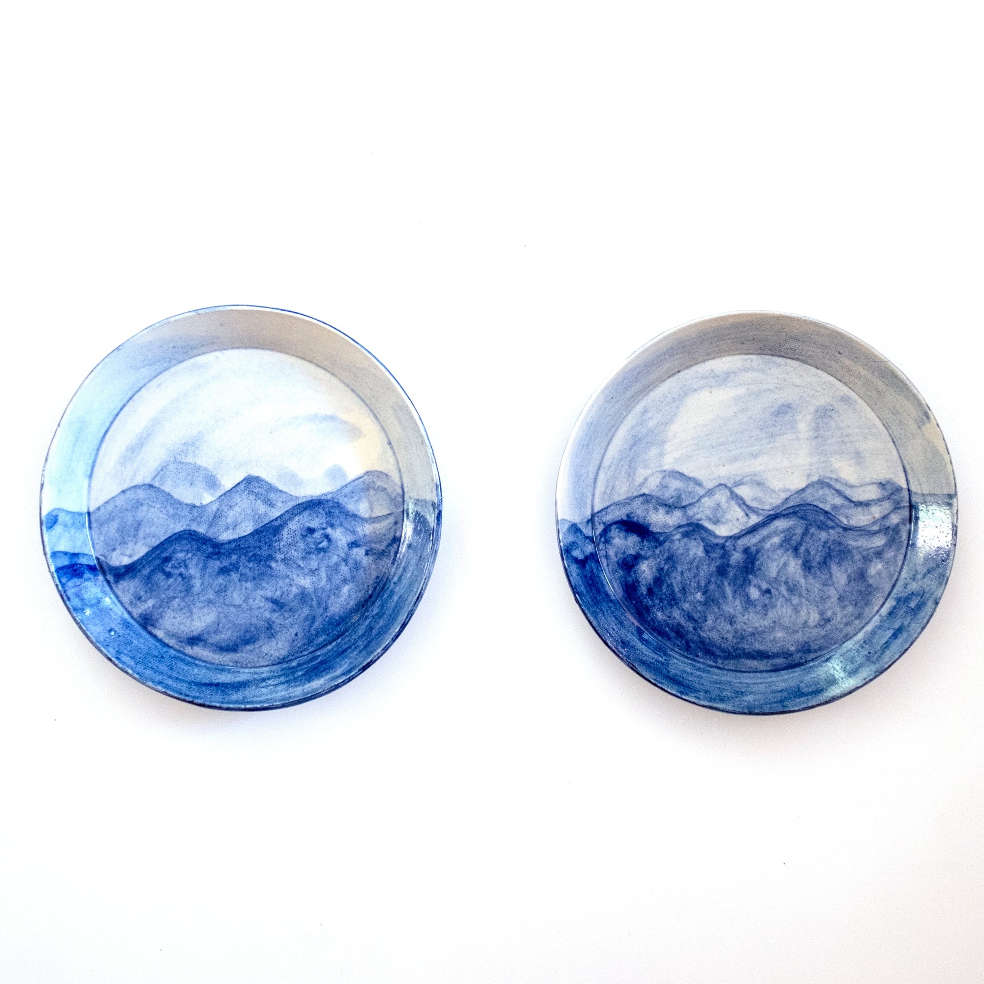 Two hand-painted porcelain PCH Small Plates with ocean-inspired designs