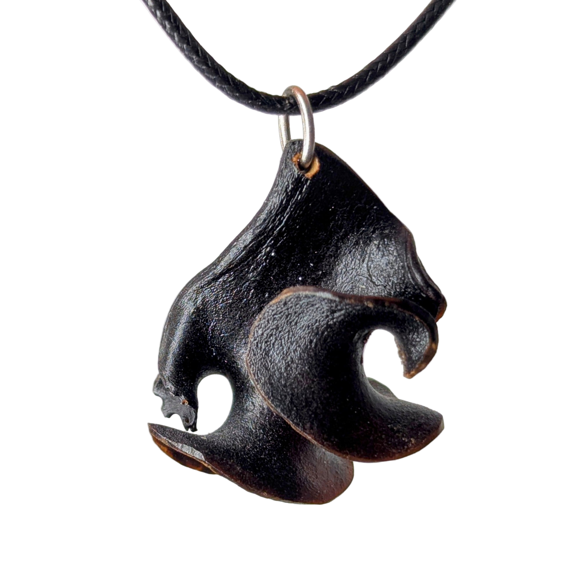 Sarphyc necklace with shadow-dark curved pendant and golden rim detail, photographed on a neutral background