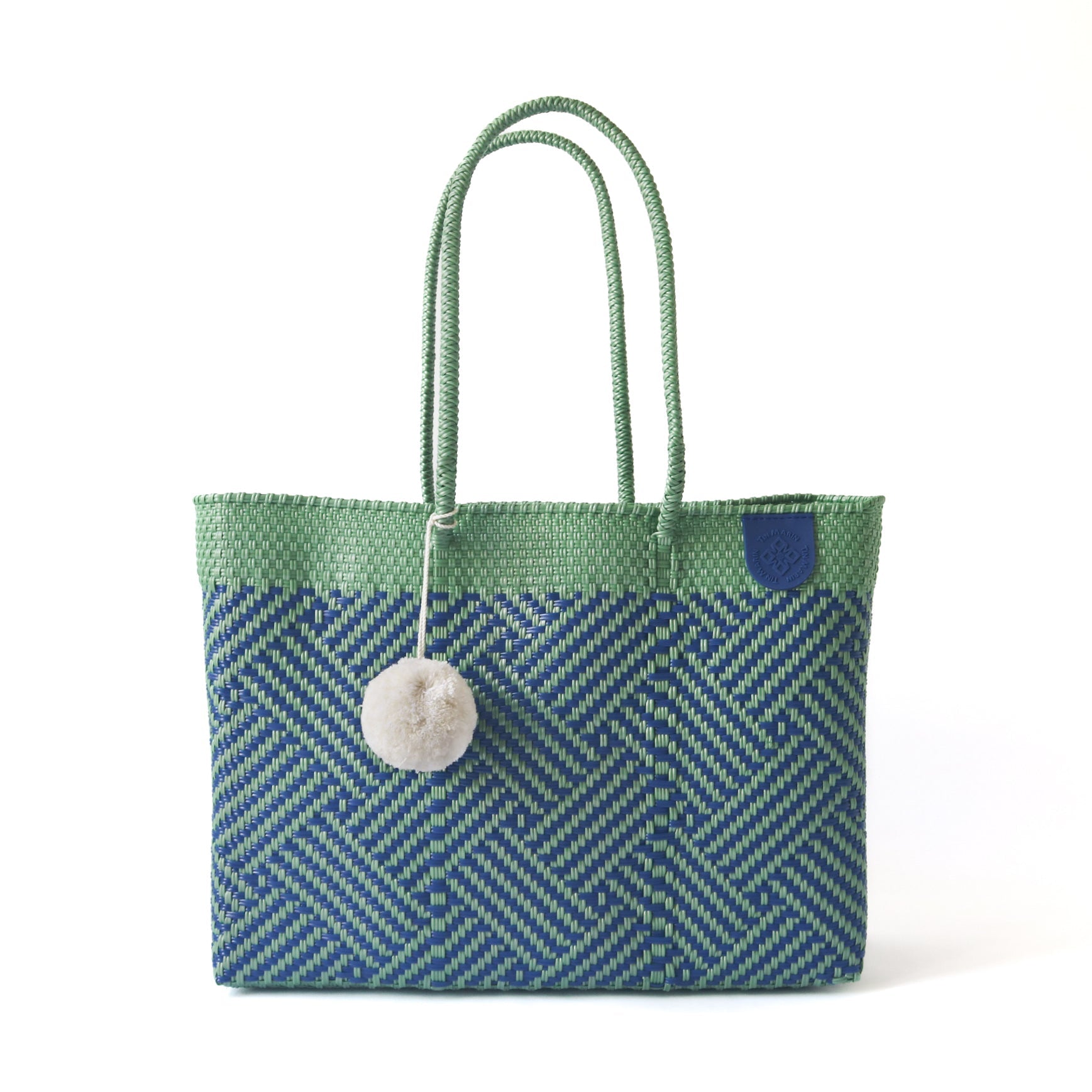 Palmera Woven Super Tote in a neutral palette showcasing woven structure and pompom