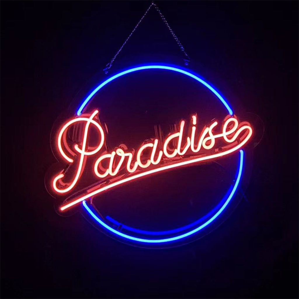 Paradise Neon Signs Light glowing with pink and orange colors, hanging against a white background.