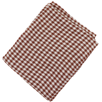 Pecan Plaid Tablecloth with warm brown gingham pattern laid over a dining table with chairs