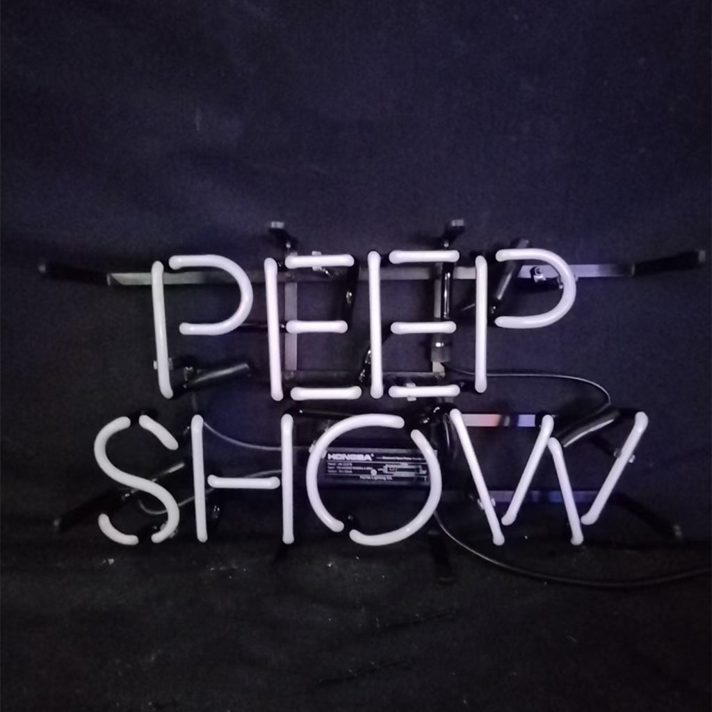 White neon tubing spelling 'PEEP SHOW' mounted on a black frame against a dark background with visible electrical cords