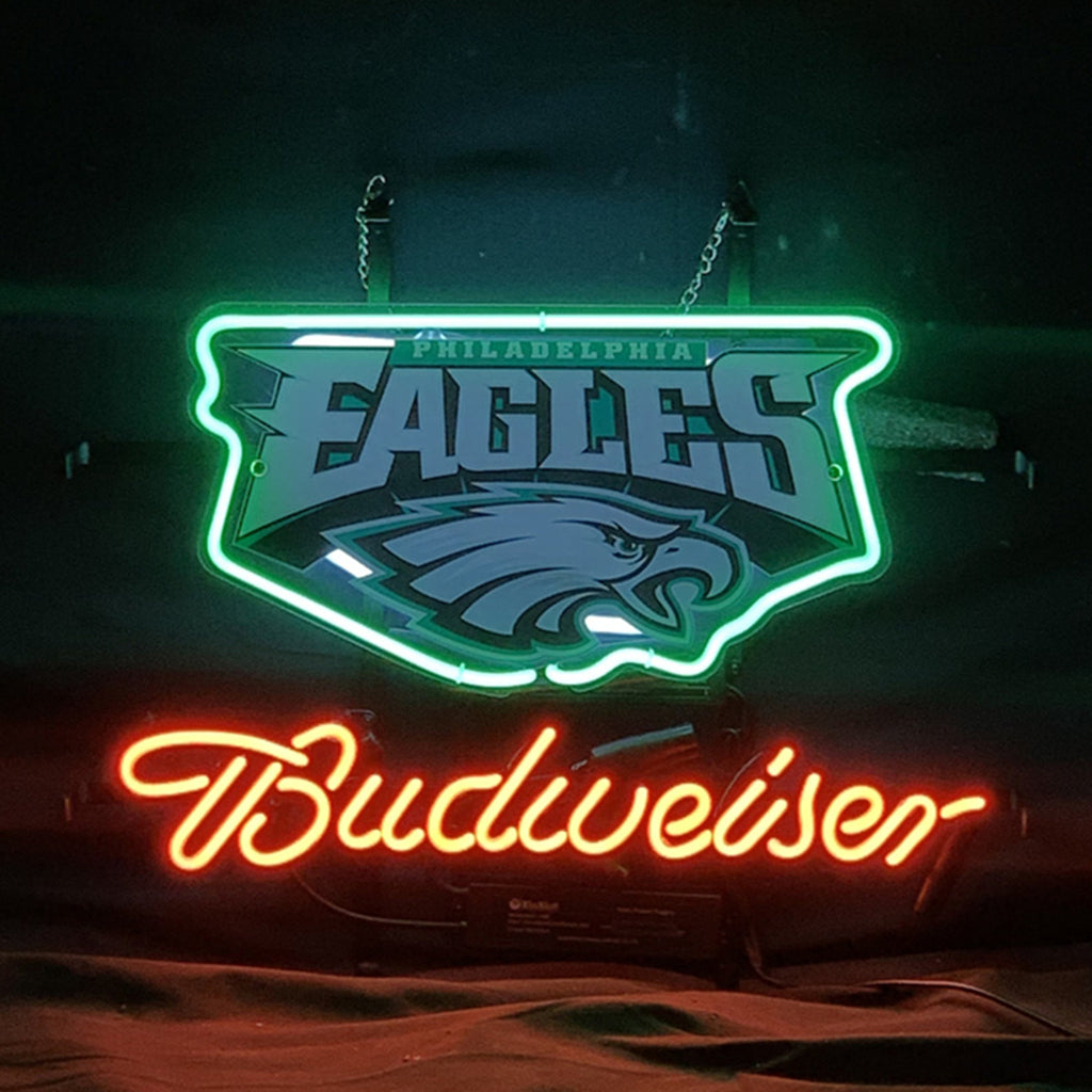Neon sign with green and white Philadelphia Eagles logo above red-orange cursive Budweiser script against a dark background