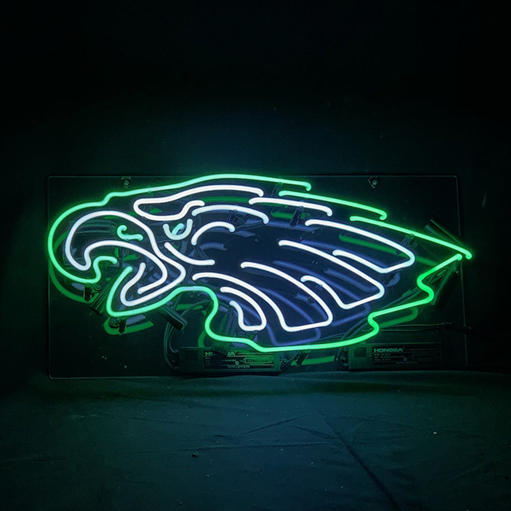 Neon sign of a stylized bird head outlined in bright green with white and blue neon accents on a black background.
