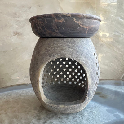 Carved soapstone essential oil burner with a tealight candle inside
