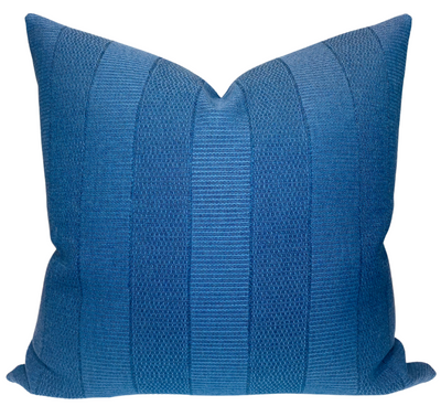 Midnight blue Asilah pillow cover by Peter Dunham Textiles displayed on a neutral sofa