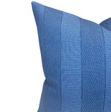 Close-up of blue Asilah pillow cover with alternating textured vertical stripes in varying weaves, showing a rich midnight blue color and fabric detail.