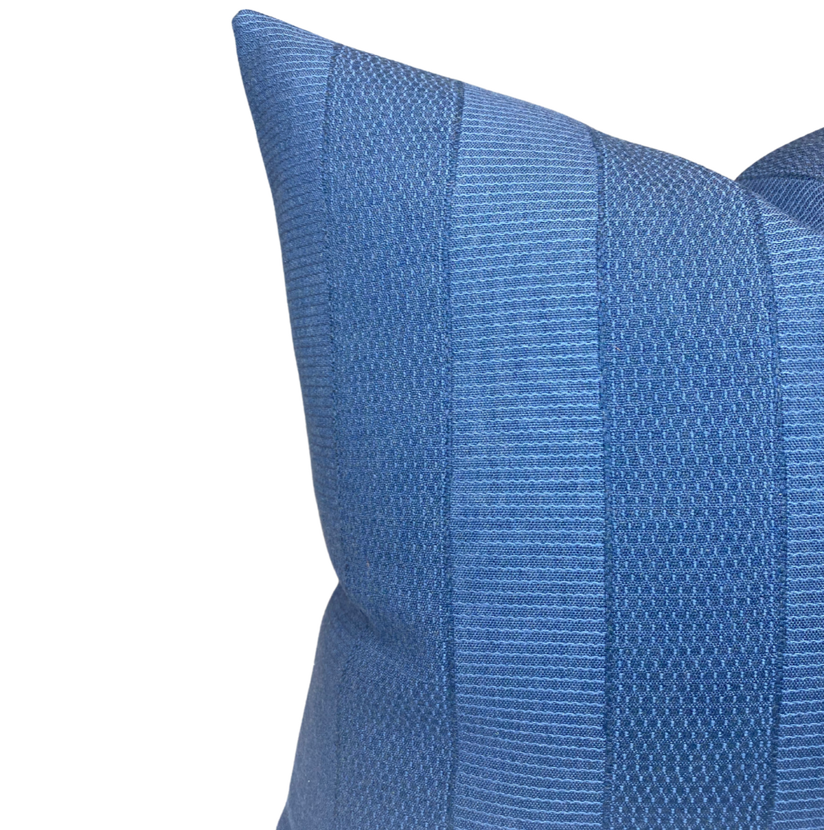 Close-up of blue Asilah pillow cover with alternating textured vertical stripes in varying weaves, showing a rich midnight blue color and fabric detail.