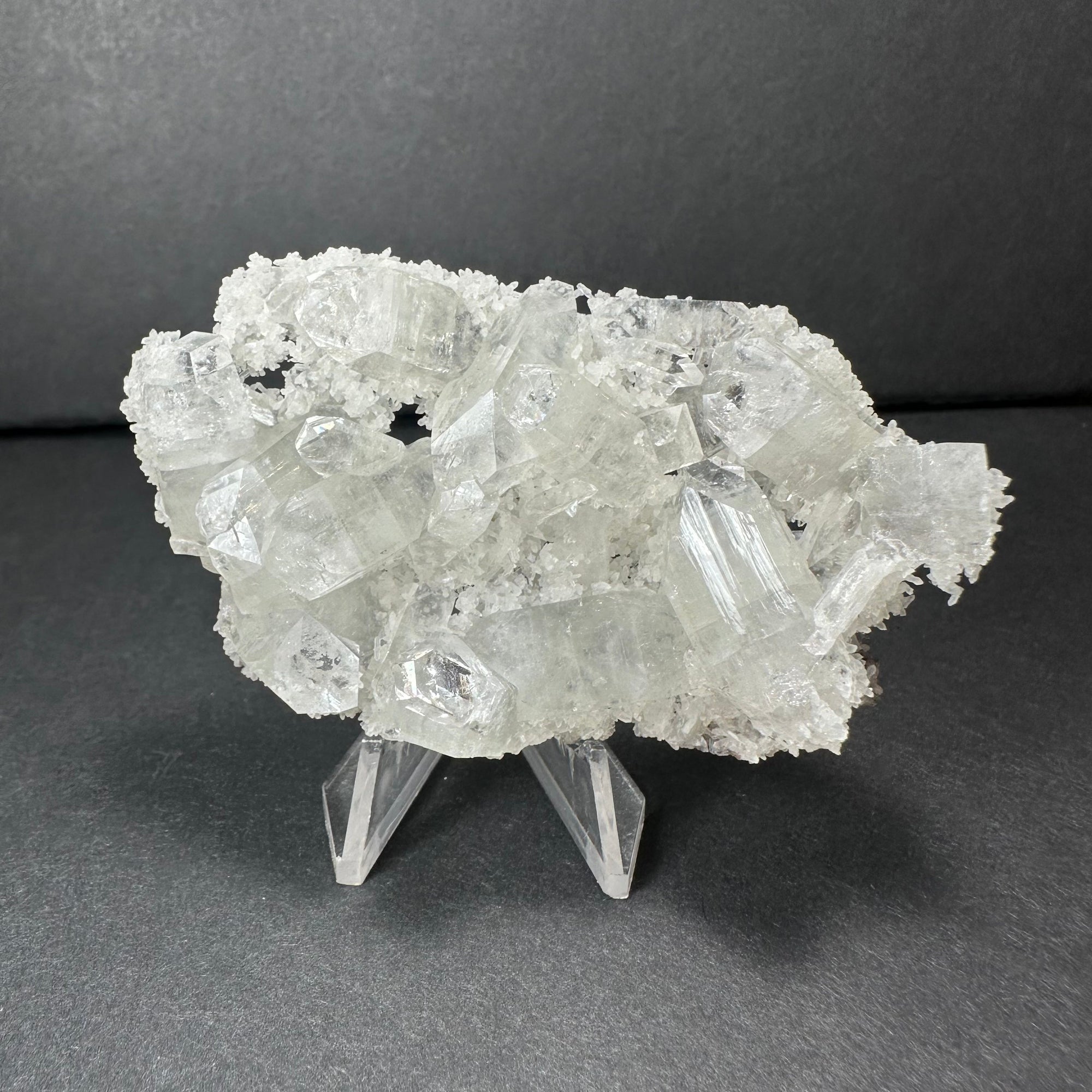 Clear Apophyllite crystal cluster micro specimen on chalcedony from India, showing translucent crystal formations