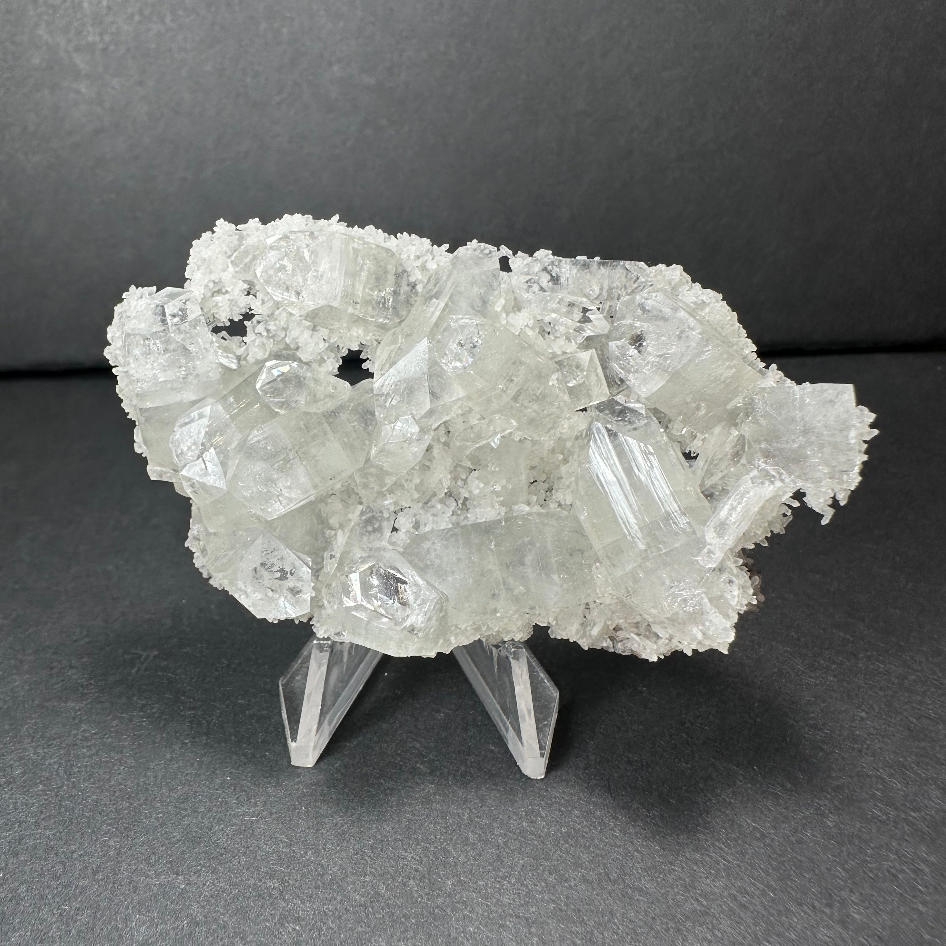 Clear Apophyllite crystal cluster micro specimen on chalcedony from India, showing translucent crystal formations