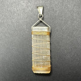 Rectangular translucent selenite pendant wrapped with thin gold wire and topped with a textured sterling silver triangular clasp on a dark gray background