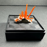 Bright orange crocoite crystals with elongated, prismatic shapes emerging from a pale white matrix on a textured black display stand with geometric patterns.
