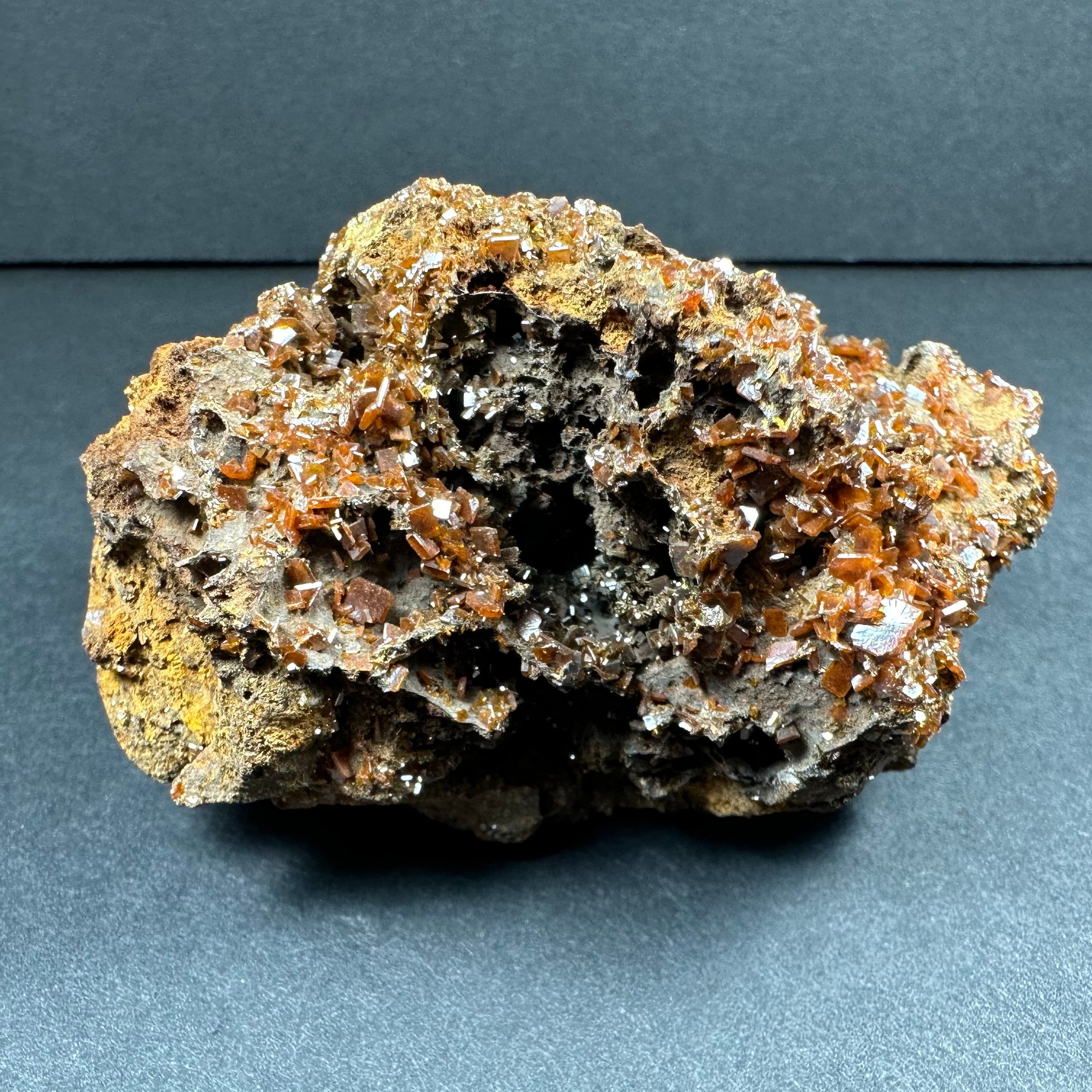 Wulfenite cluster on matrix from Maoniuping Mine, showing vivid orange crystals