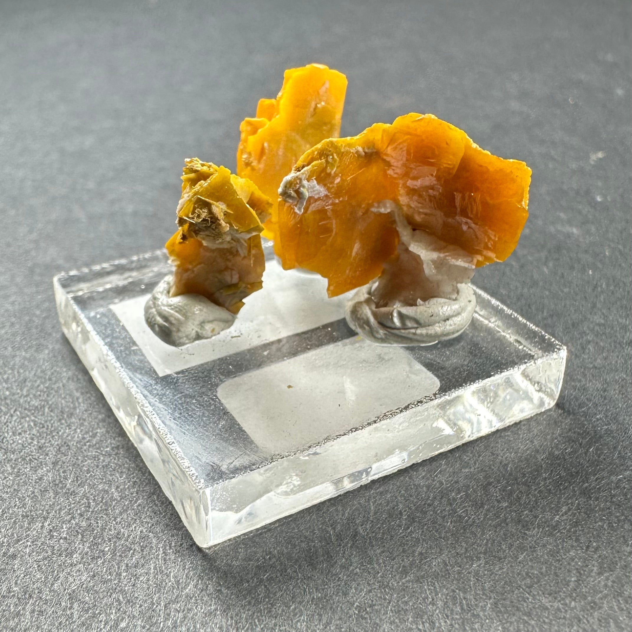 Micro Wulfenite Crystal Cluster on clear acrylic square