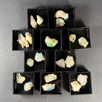 Welo Opal specimen from Ethiopia in a small square clear acrylic box.