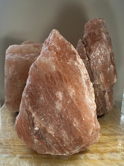 Himalayan Pink Salt Lamp glowing softly on a bedside table