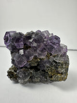 Purple dodecahedral fluorite crystals on a calcite matrix from China