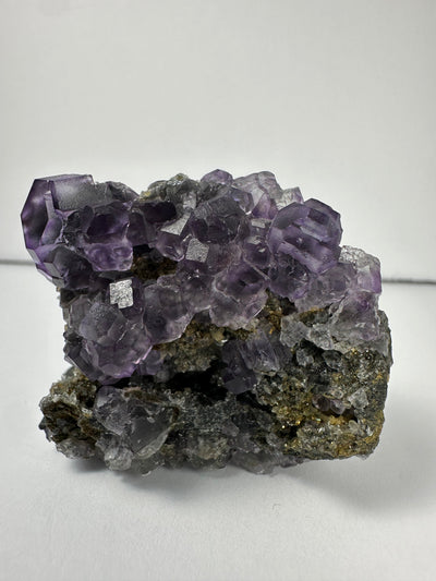 Purple dodecahedral fluorite crystals on a calcite matrix from China