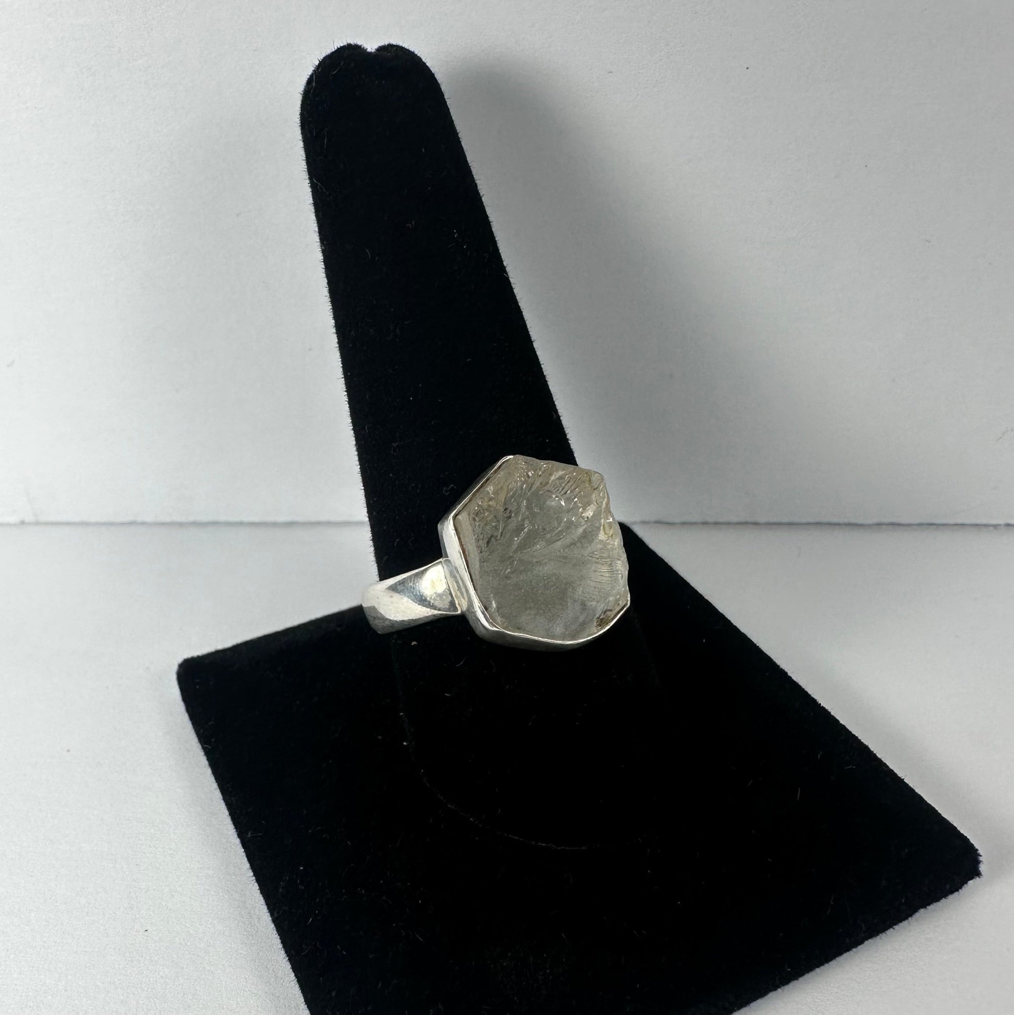 Natural rough quartz ring on a white background illustrating unpolished quartz stone set in sterling silver band