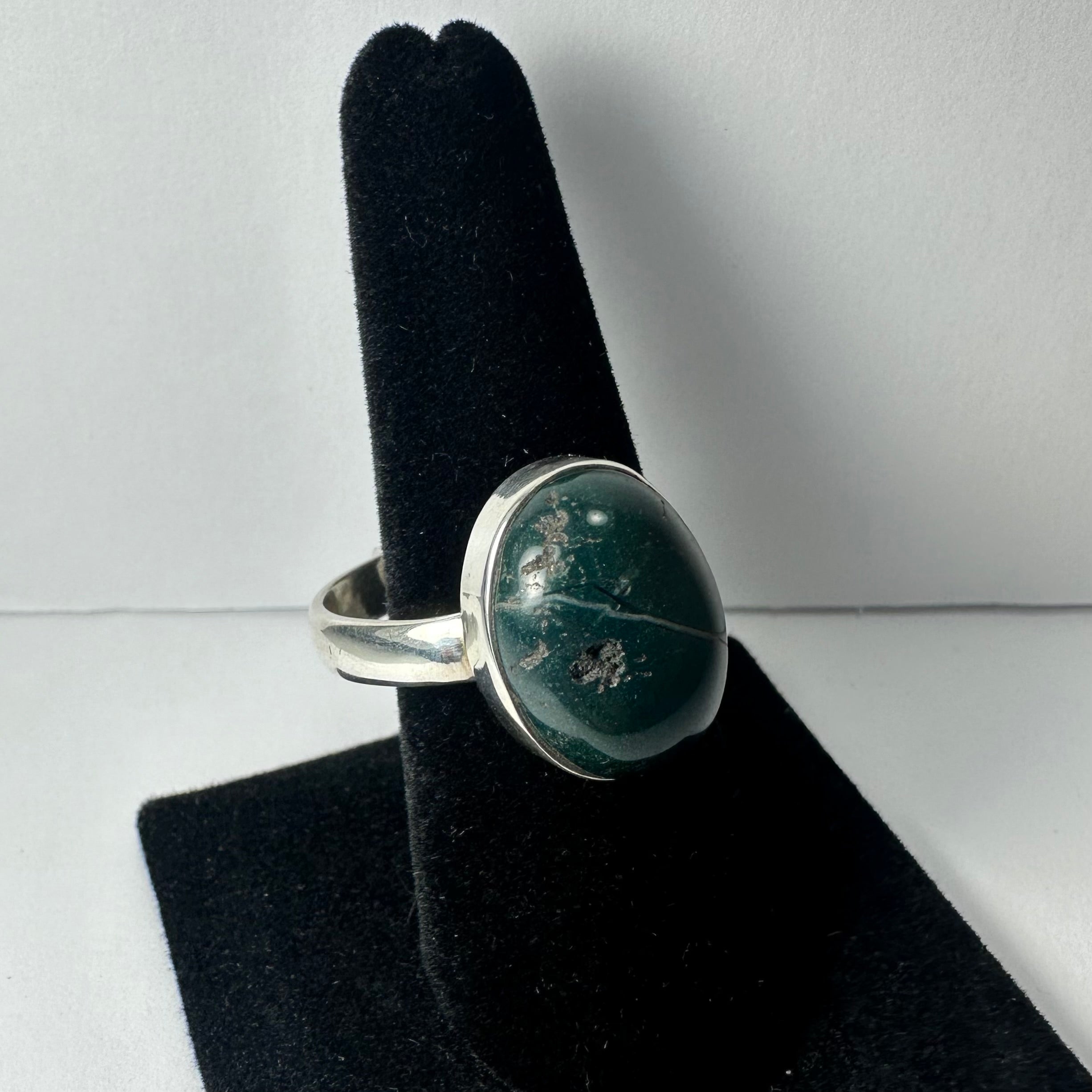 Close-up of Serpentine ring with green gemstone set in a polished silver band