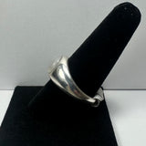 Silver ring with a round moonstone cabochon set in a polished wide band, displayed on a black velvet ring holder against a neutral background.