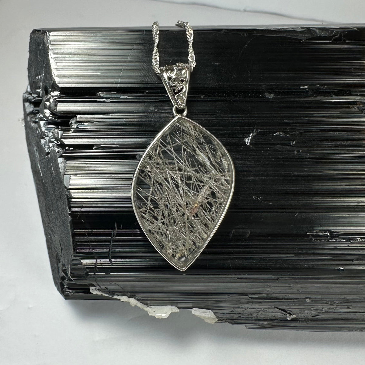 Close-up view of Rutilated Quartz Flame Pendant with silver clasp