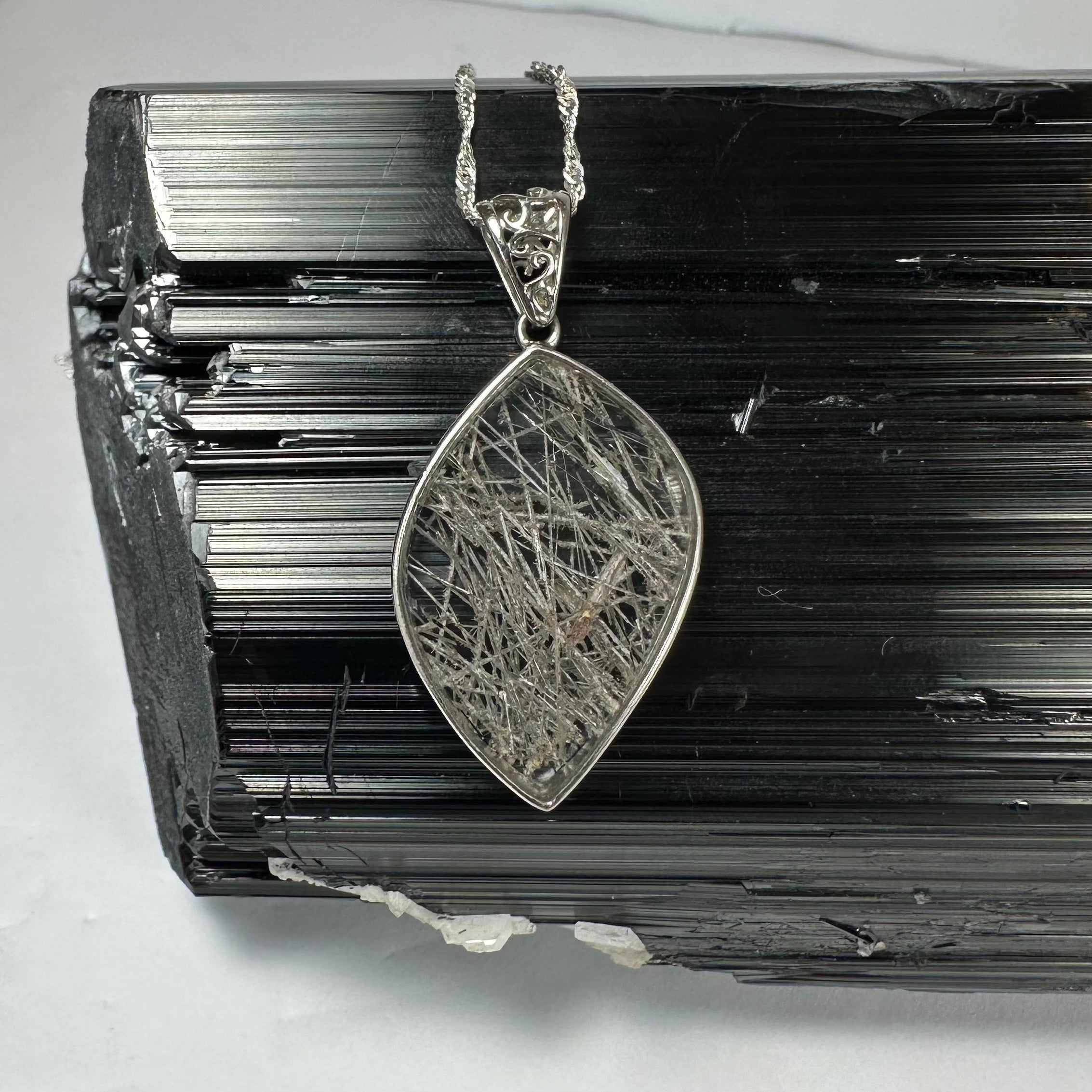 Close-up view of Rutilated Quartz Flame Pendant with silver clasp